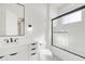 Modern bathroom featuring a glass shower, sleek vanity with gray countertop, and black hardware at 1805 Goldenrod St, Sarasota, FL 34239