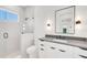 Modern bathroom featuring a glass shower, sleek vanity with gray countertop, and black hardware at 1805 Goldenrod St, Sarasota, FL 34239