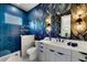 Stylish bathroom with leaf-patterned wallpaper, blue-tiled shower, and modern vanity at 1805 Goldenrod St, Sarasota, FL 34239