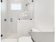 Bathroom showcasing a modern shower design, white tiled walls, and black hardware at 1805 Goldenrod St, Sarasota, FL 34239