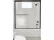 Modern bathroom featuring a shower-tub, tiled walls, and black hardware at 1805 Goldenrod St, Sarasota, FL 34239
