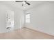 Bright bedroom with hardwood floors, large window, and a view into the en-suite bathroom at 1805 Goldenrod St, Sarasota, FL 34239