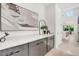A clean butler's pantry featuring grey cabinets, light counter tops, and an undermount sink at 1805 Goldenrod St, Sarasota, FL 34239