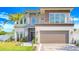 Beautiful two-story modern home featuring clean lines, balcony, lush landscaping, and an attached two-car garage at 1805 Goldenrod St, Sarasota, FL 34239