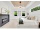 Bright main bedroom featuring fireplace, and light hardwood floors at 1805 Goldenrod St, Sarasota, FL 34239