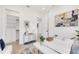 Bright home office featuring white desk, modern art, and closet with built-in shelving at 1805 Goldenrod St, Sarasota, FL 34239