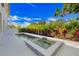 Sparkling pool and spa surrounded by vibrant landscaping offering a serene and private backyard retreat at 1805 Goldenrod St, Sarasota, FL 34239