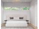 Bright, minimalist bedroom with large bed and natural light at 601 Tremont St, Sarasota, FL 34242