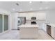 Modern kitchen with white cabinets, island, and stainless steel appliances at 12520 Galapagos Ct # 207, Venice, FL 34293
