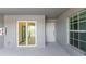 Covered patio with sliding glass doors and exterior door at 12520 Galapagos Ct # 207, Venice, FL 34293