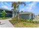 Modern building with walkway, landscaping, and attached garage at 12520 Galapagos Ct # 207, Venice, FL 34293