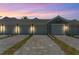 Evening view of a row of attached garages with paved driveways at 12520 Galapagos Ct # 207, Venice, FL 34293
