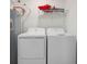Laundry room with washer, dryer, and shelving at 12520 Galapagos Ct # 207, Venice, FL 34293