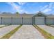 Exterior view of a row of garages with a paved driveway at 12520 Galapagos Ct # 207, Venice, FL 34293