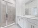 Bathroom with shower, double vanity, and modern finishes at 12520 Galapagos Ct # 207, Venice, FL 34293