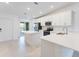 Modern kitchen with white cabinets, island, and stainless steel appliances at 12520 Galapagos Ct # 207, Venice, FL 34293
