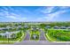 Aerial view of community entrance with landscaping and a pond at 12520 Galapagos Ct # 207, Venice, FL 34293