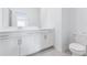 Clean bathroom with double vanity and a toilet at 12520 Galapagos Ct # 207, Venice, FL 34293
