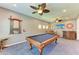 This entertainment space includes a classic pool table, custom bar area and stylish ceiling fans at 11342 77Th E St, Parrish, FL 34219