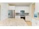 Well-lit kitchen with white cabinets, stainless steel appliances, and an island at 11342 77Th E St, Parrish, FL 34219