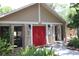 Community building with red doors and landscaping at 1213 Tallywood Dr # 7007, Sarasota, FL 34237