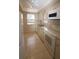 Galley kitchen with white appliances and tile floor at 1213 Tallywood Dr # 7007, Sarasota, FL 34237