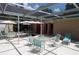 Community pool area with tables and lounge chairs at 1213 Tallywood Dr # 7007, Sarasota, FL 34237