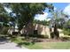 Condo exterior showcasing landscaping and trees at 1213 Tallywood Dr # 7007, Sarasota, FL 34237