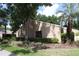 Condo exterior showcasing landscaping and trees at 1213 Tallywood Dr # 7007, Sarasota, FL 34237