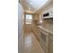 Galley kitchen with white appliances and tile floor at 1213 Tallywood Dr # 7007, Sarasota, FL 34237