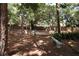 Fenced pet area with bench and mature trees at 1213 Tallywood Dr # 7007, Sarasota, FL 34237