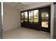 Bright screened porch with tile floor and view of lush landscaping at 1213 Tallywood Dr # 7007, Sarasota, FL 34237