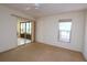 Bedroom with sliding glass doors to patio and ceiling fan at 1213 Tallywood Dr # 7007, Sarasota, FL 34237