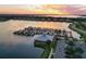 Sunset view of marina with many boats and clubhouse at 1020 Tidewater Shores Loop # 108, Bradenton, FL 34208