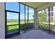 Screened porch with view of water and landscaping at 1020 Tidewater Shores Loop # 108, Bradenton, FL 34208