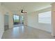 Spacious living room with tile floors and sliding glass doors leading to a patio with water views at 1020 Tidewater Shores Loop # 108, Bradenton, FL 34208