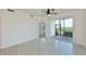 Living room with tile floors, access to patio and water views at 1020 Tidewater Shores Loop # 108, Bradenton, FL 34208