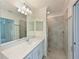 Bathroom with white vanity, quartz countertop and walk-in shower at 1020 Tidewater Shores Loop # 108, Bradenton, FL 34208