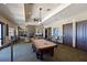 Game room featuring a pool table and stone fireplace at 1020 Tidewater Shores Loop # 108, Bradenton, FL 34208