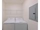 Laundry room with washer, dryer, and shelving at 1020 Tidewater Shores Loop # 108, Bradenton, FL 34208
