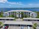 Waterfront condo building featuring covered parking and beautiful landscaping at 1020 Tidewater Shores Loop # 108, Bradenton, FL 34208