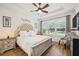 Bright bedroom with a king-size bed and wood flooring at 10343 Highland Park Pl, Palmetto, FL 34221