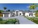 White two-story house with gray roof, landscaping, and a three-car garage at 1800 Webber St, Sarasota, FL 34239