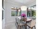 A light-filled dining area features a modern chandelier and views of the outdoor space at 8244 Larkspur Cir, Sarasota, FL 34241