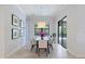 Bright dining room featuring an elegant chandelier, backyard views, and neutral wall colors at 8244 Larkspur Cir, Sarasota, FL 34241