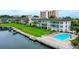 Beautiful aerial view of a waterfront condo building with pool, boat docks, and lush landscaping at 4350 Chatham Dr # E307, Longboat Key, FL 34228