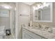 Bathroom with granite countertop, white vanity, and a walk-in shower at 4350 Chatham Dr # E307, Longboat Key, FL 34228