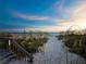 A sandy path through seagrass leads to the beach at sunset at 4350 Chatham Dr # E307, Longboat Key, FL 34228