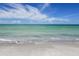 Waves gently lap the shore of the pristine beach at 4350 Chatham Dr # E307, Longboat Key, FL 34228
