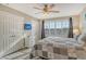 Bedroom with a king-size bed, white wicker furniture, and plantation shutters at 4350 Chatham Dr # E307, Longboat Key, FL 34228